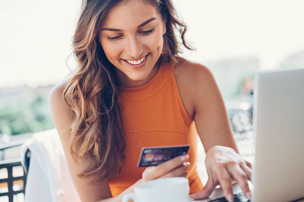 Picture of a woman paying with a credit card.
