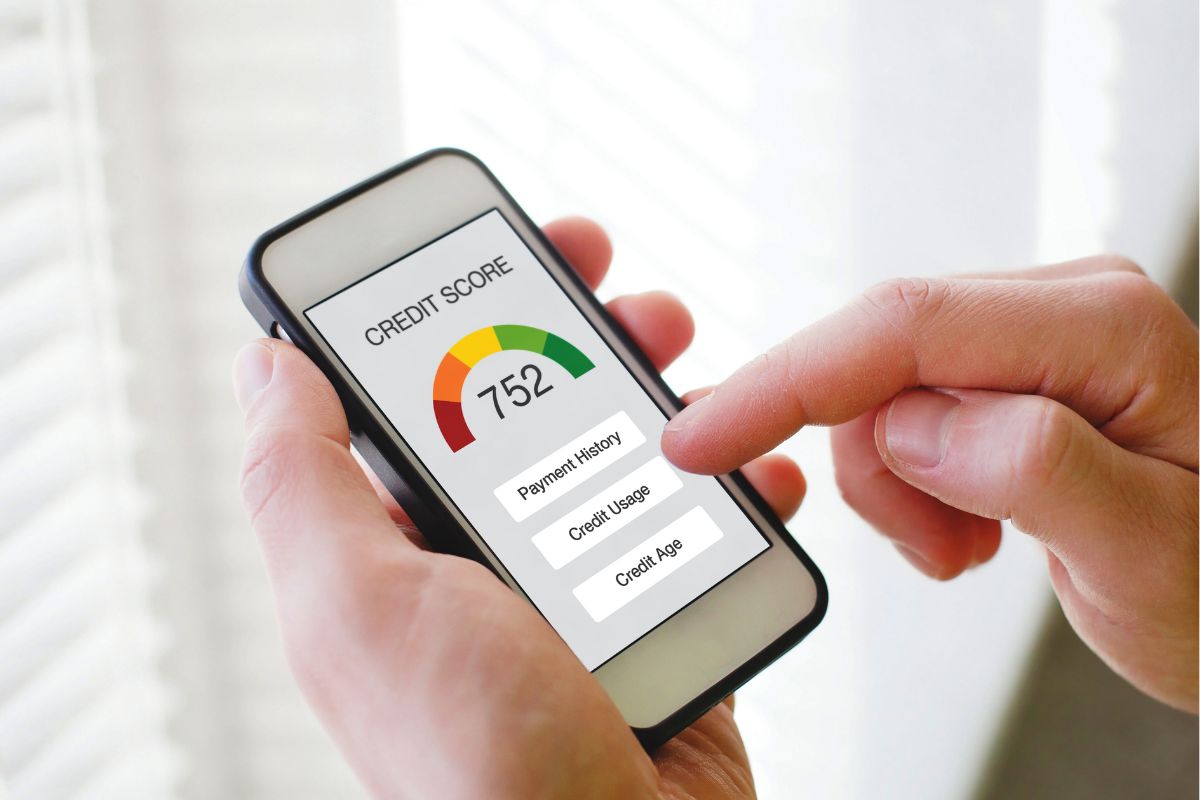 A man's hand checking his credit score.