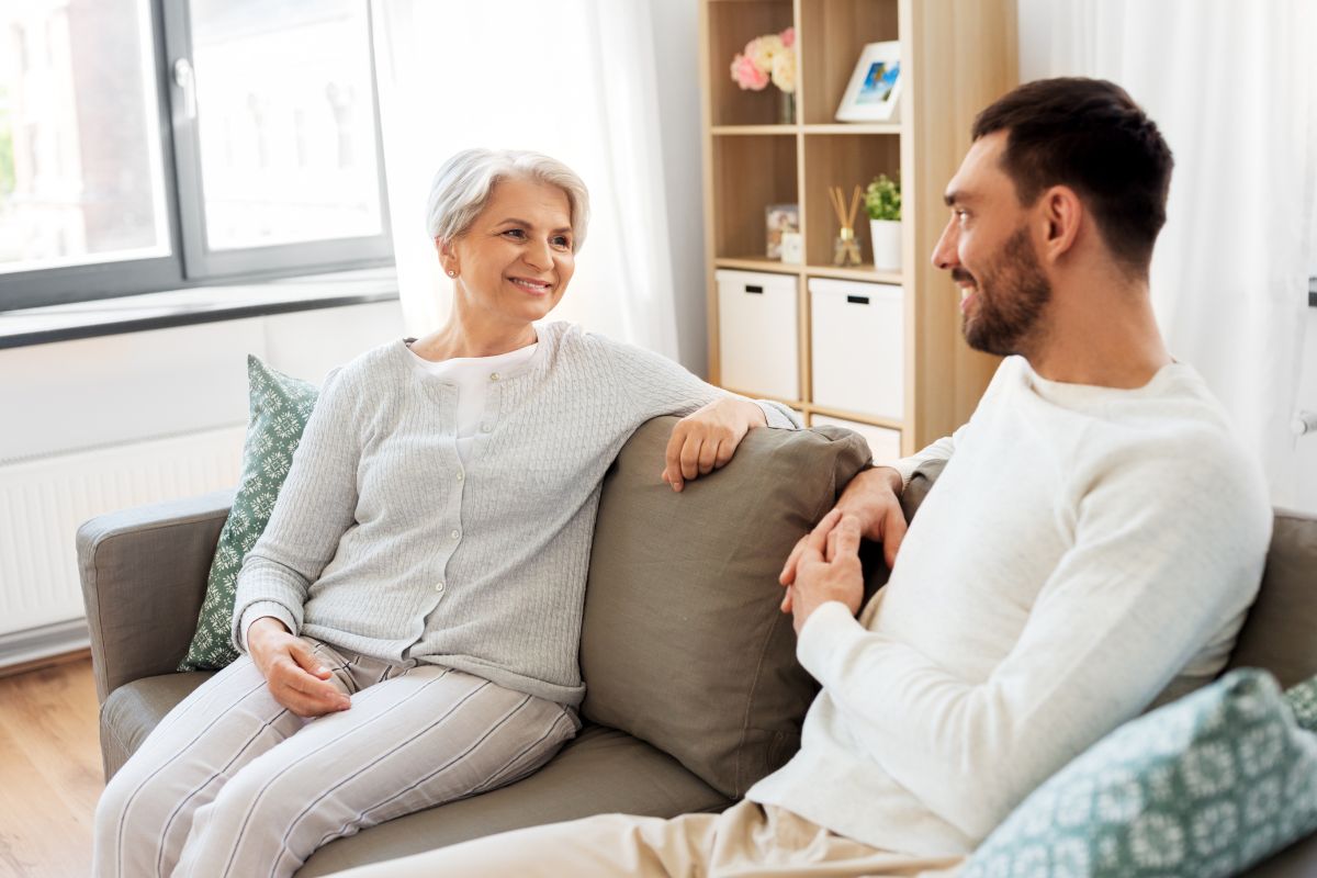 The picture shows a mother and son talking.