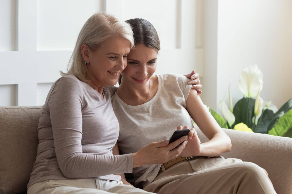 Photo of a daughter teaching her mother about phones.