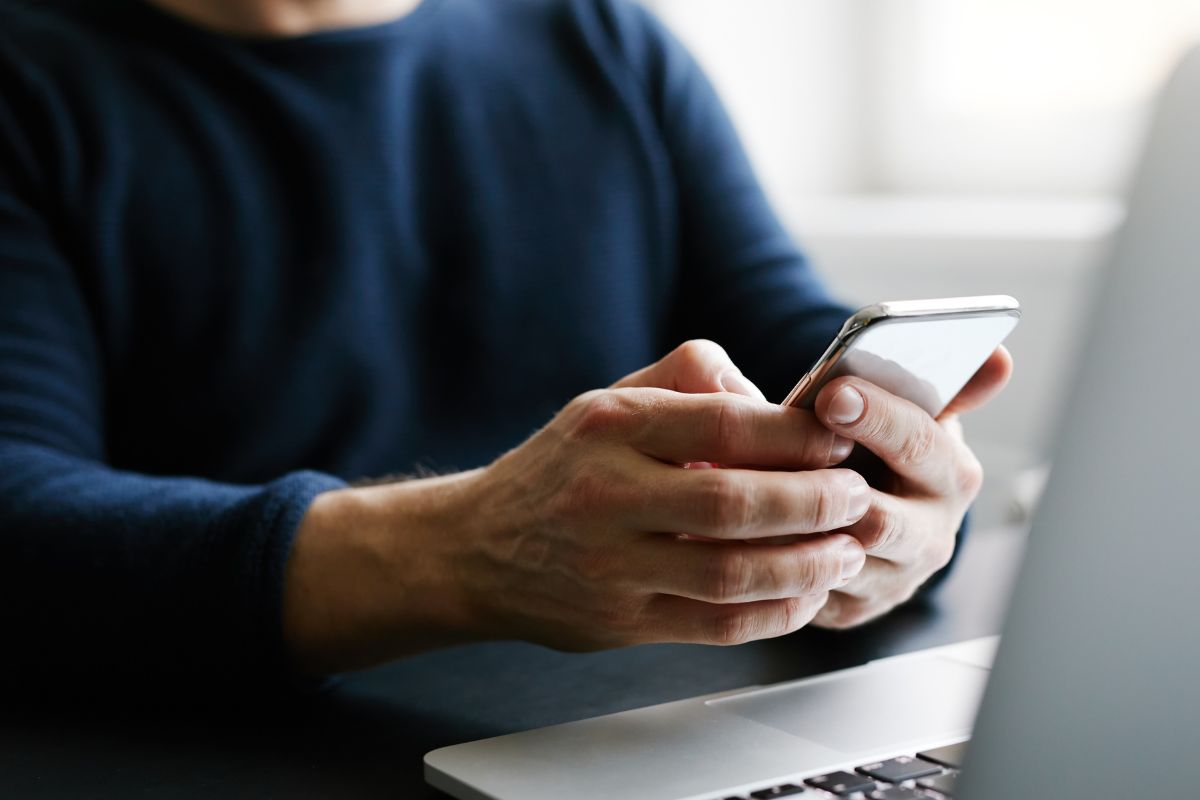 Picture of a man using a phone.