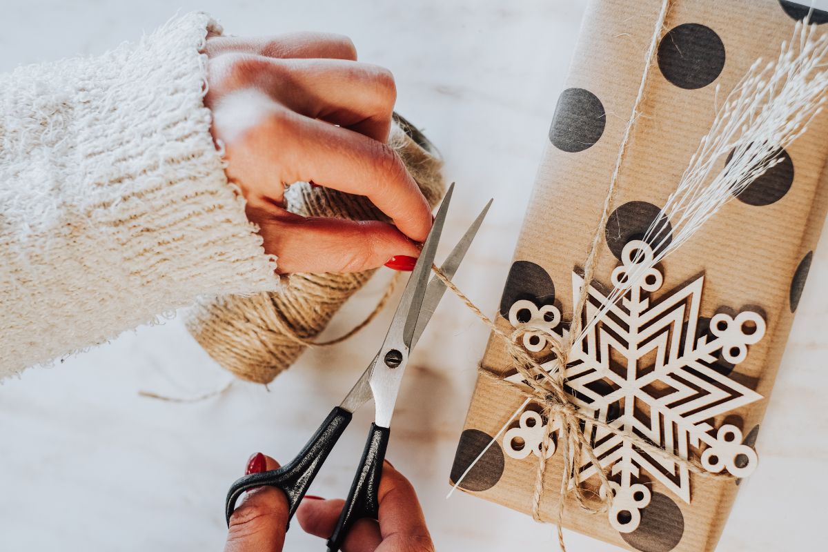 A woman's hand making a handmade gift.