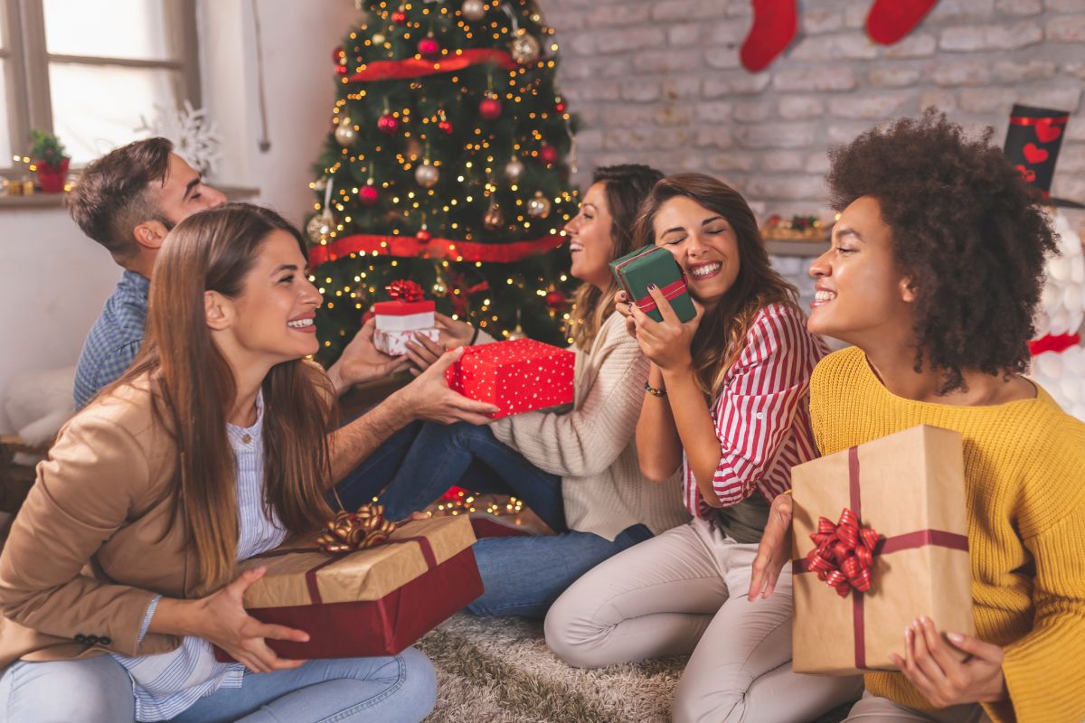 The image shows a group of friends exchanging gifts.