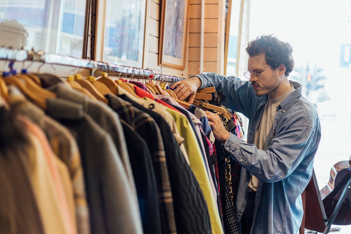 The hand of a man shopping in the thrift store.