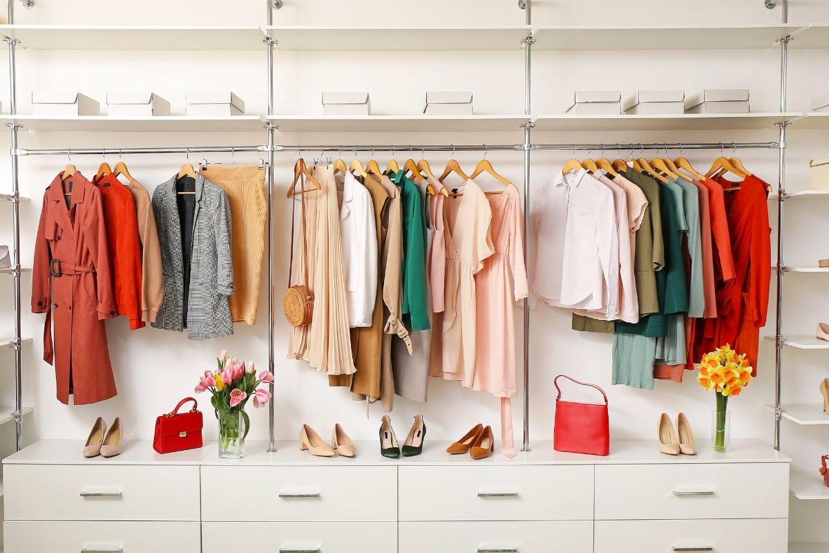 Picture of hung clothes, shoes, and bags.