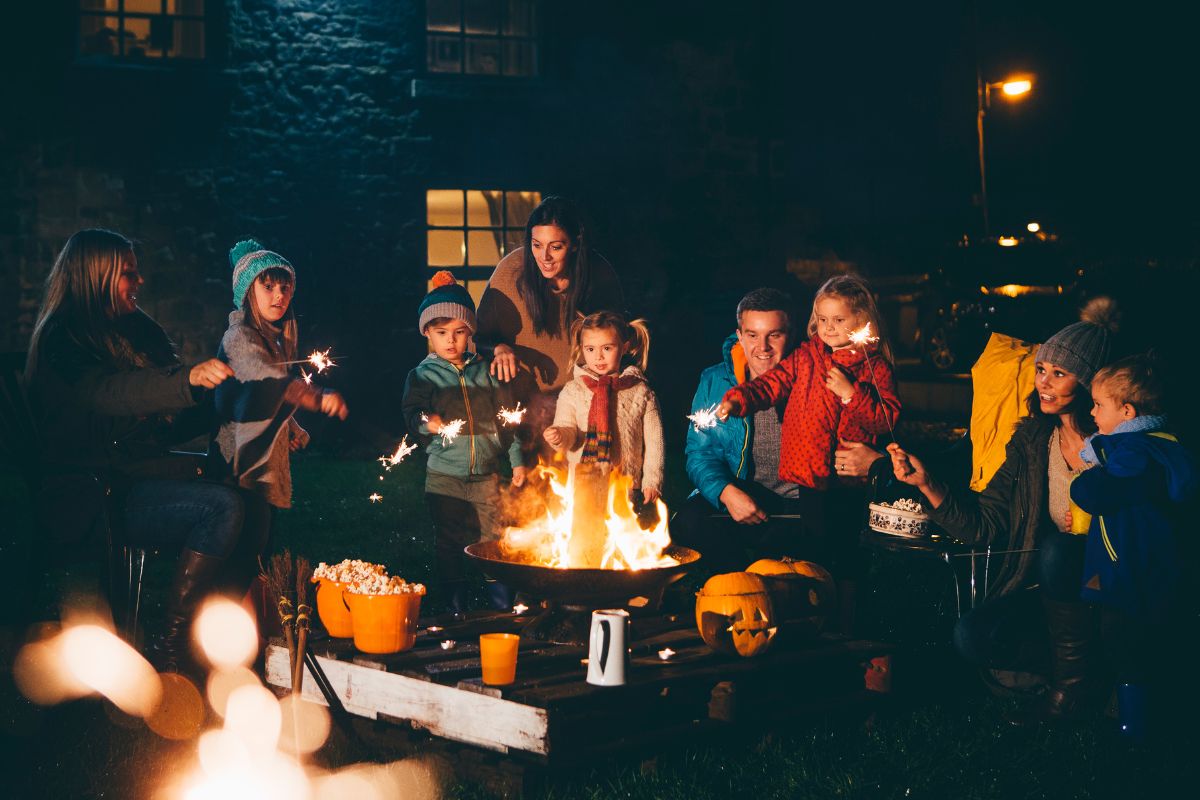 The image shows a family enjoying a bonfire.