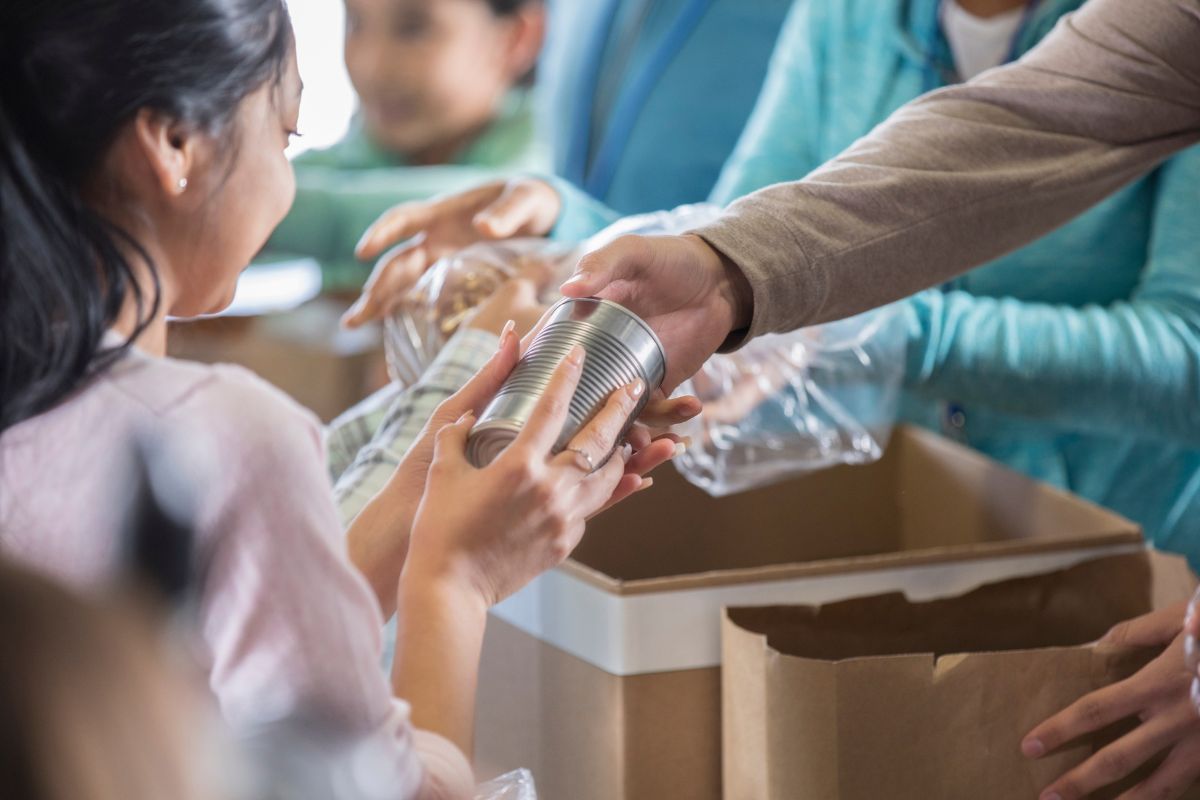 The image shows a group of people conducting a charity.