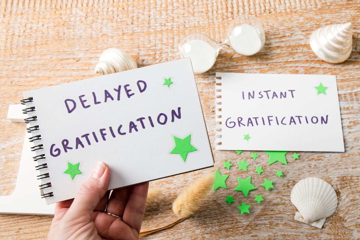 The image shows papers with delayed gratification wordings.