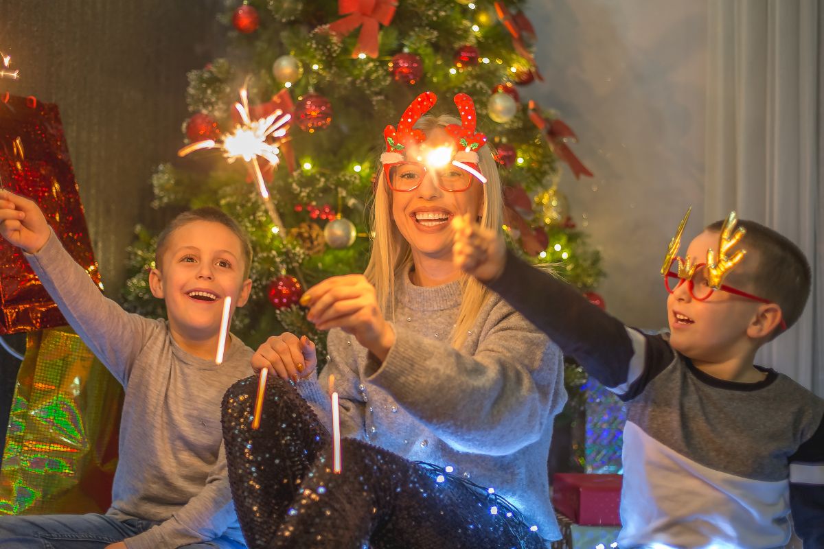 The image shows kids and women celebrating Christmas.