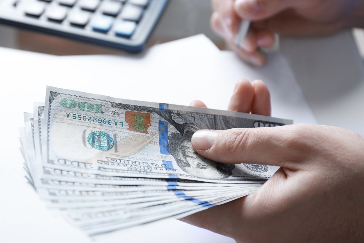A woman's hand budgeting her finances.