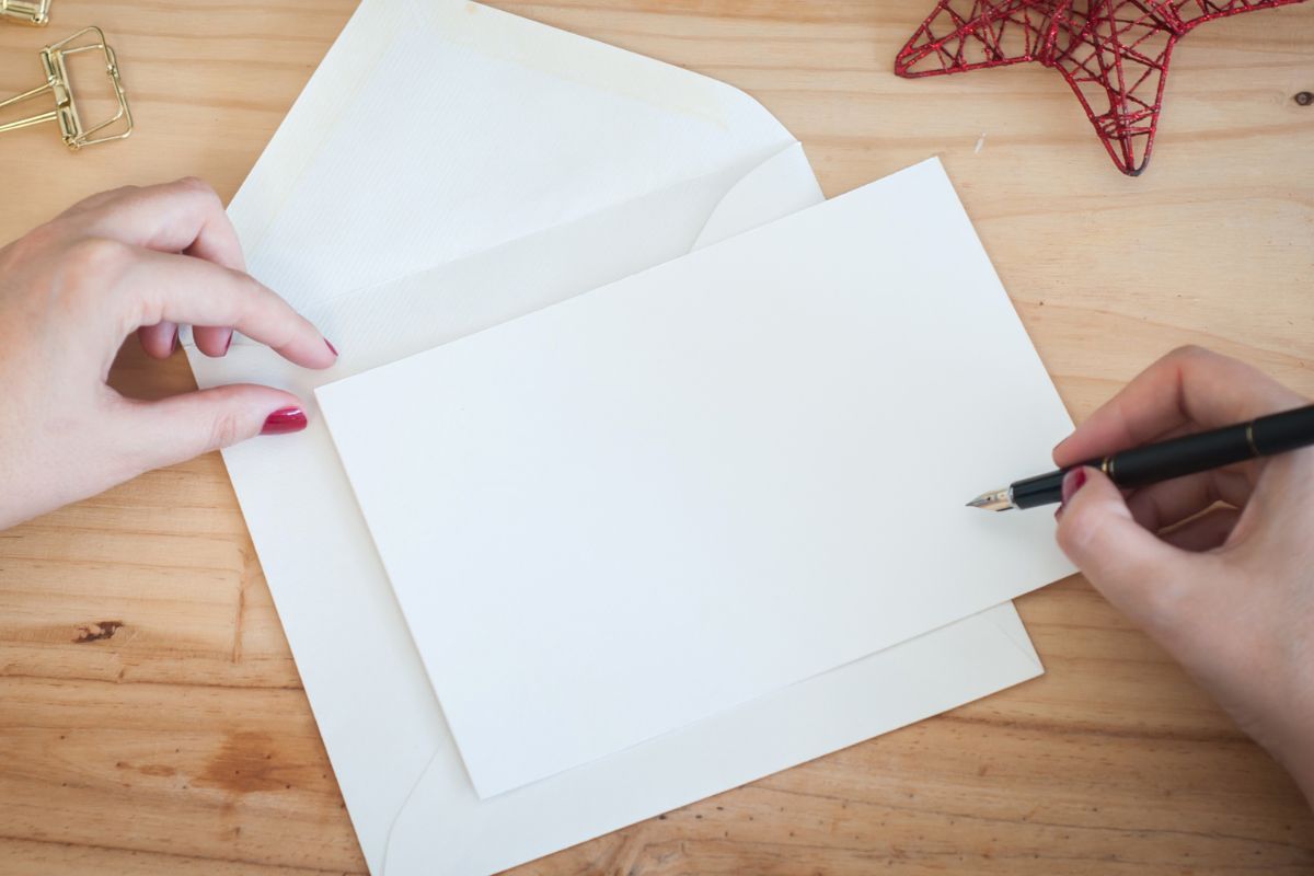 A woman's hand is writing a letter.