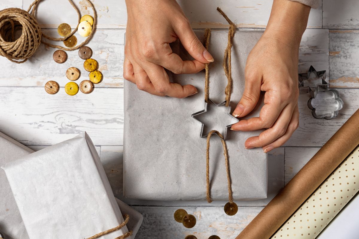 A woman's hand wrapping gifts.
