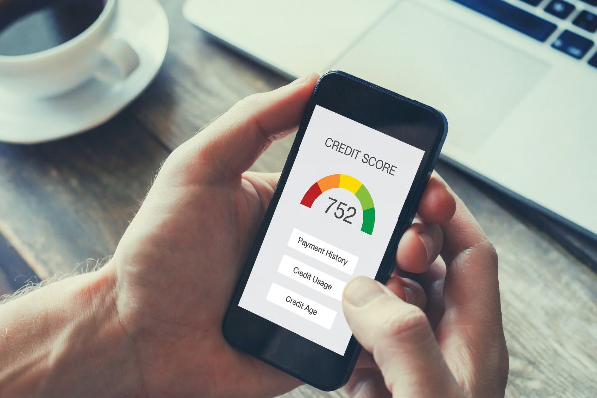 A man's hand checking his credit score.