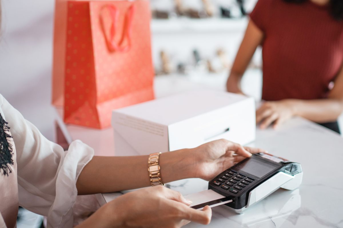 A woman is paying with a credit card.