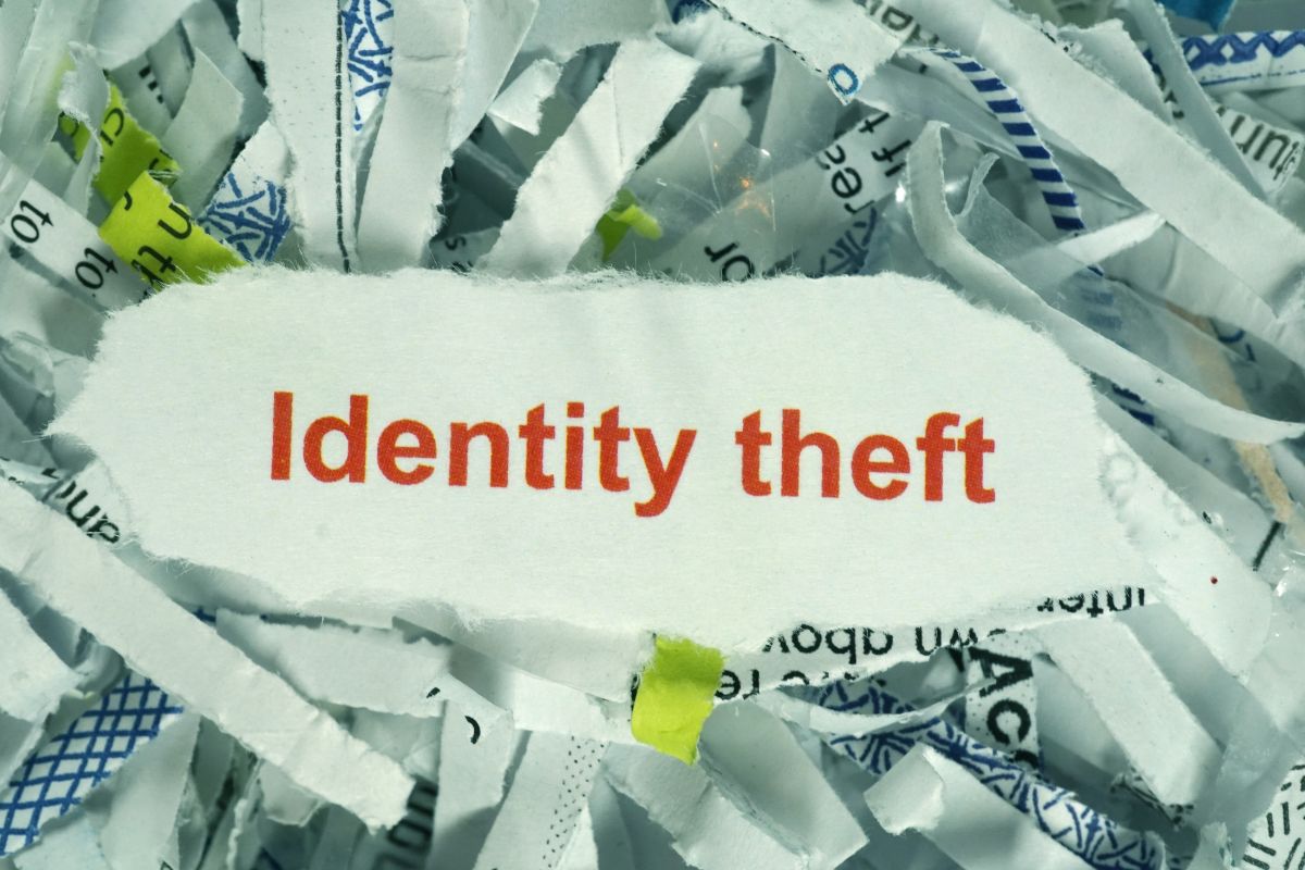 The picture shows a paper with identity theft wording.