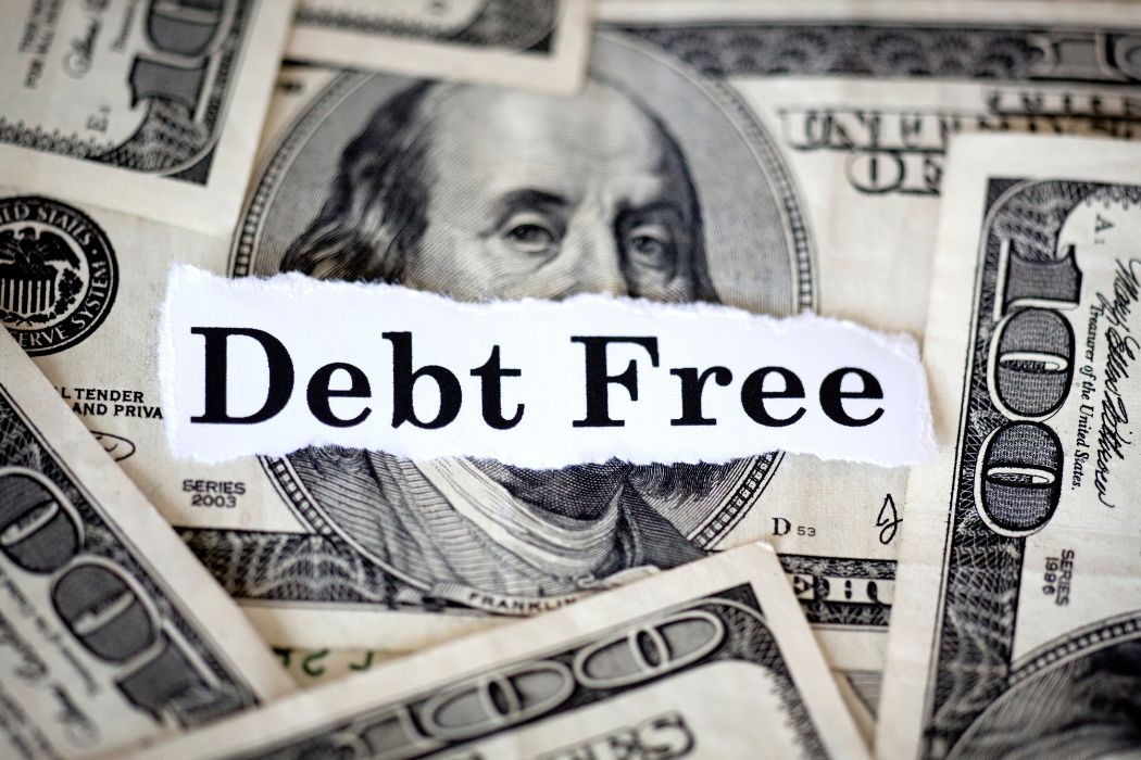 Image of money and debt wording.