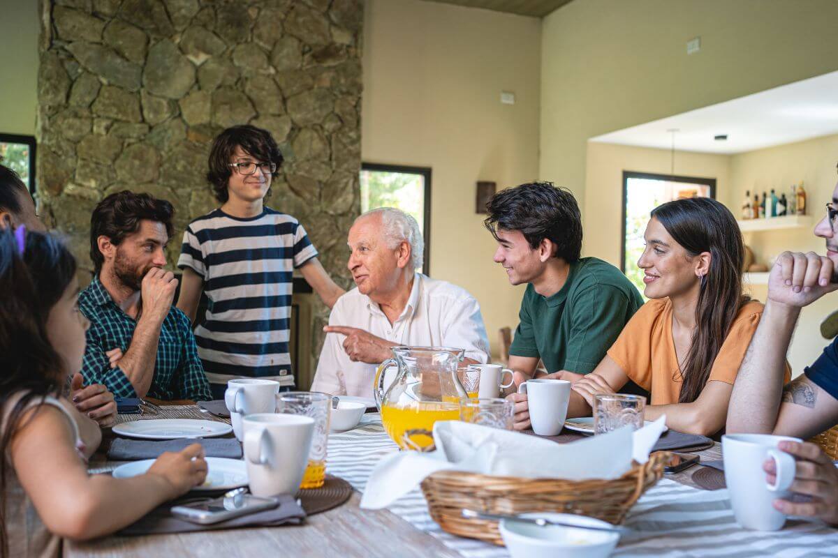 The picture shows a group of family conversations over breakfast which refers to setting clear expectations with the family about budget-friendly gifts that help everyone feel comfortable with lower-cost options.