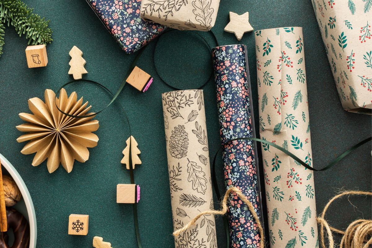 The photo shows craft papers, yarn, and gift wrappers indicating that skipping unnecessary extras like fancy wrappers is a quick way to save more for meaningful gifts.