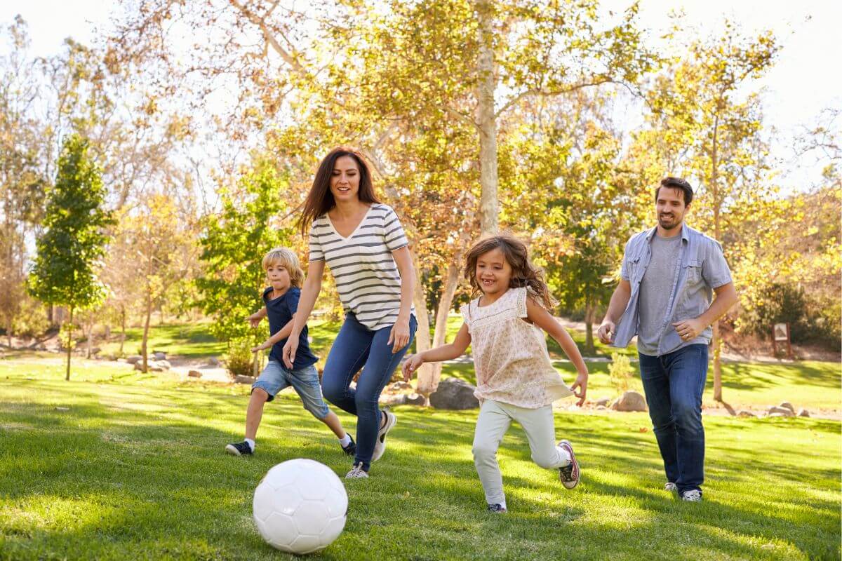 The photo shows a family playing soccer together in the field which means scheduling regular family activities that keep connections strong and balance your time.