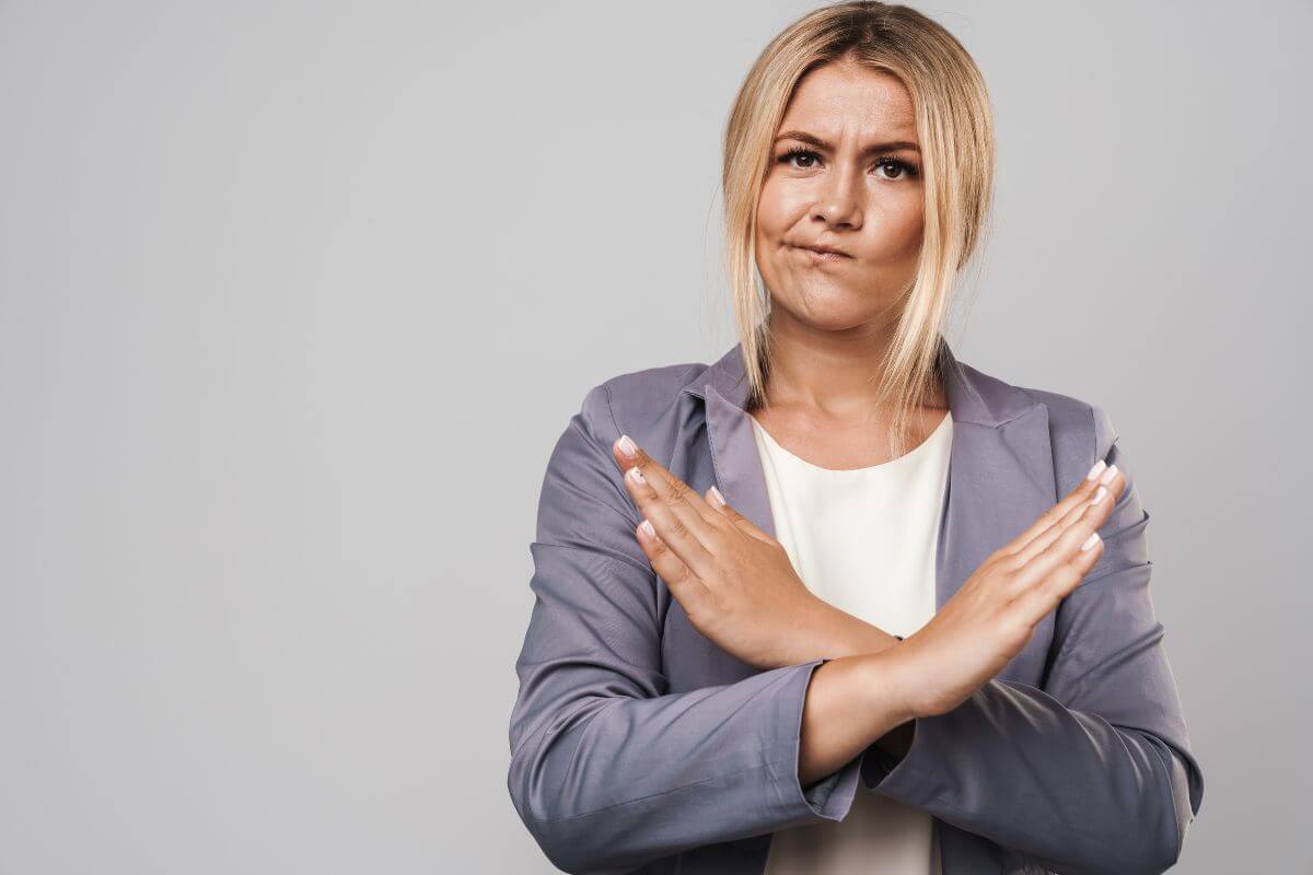 The image tells about a girl crossing both arms indicating to learn to say no to non-essential tasks that affect family time.