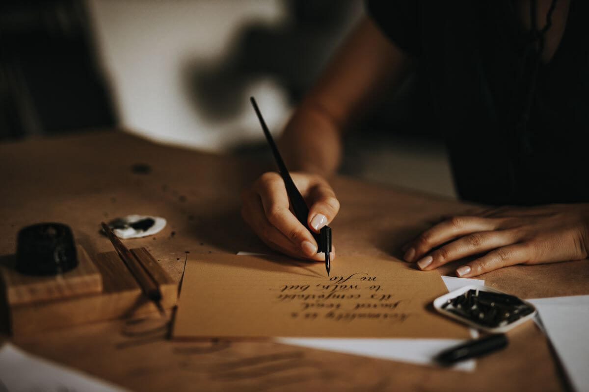 The picture of the girl's hand and writing on the paper refer to writing letters to loved ones to connect and share holiday cheer even from afar.