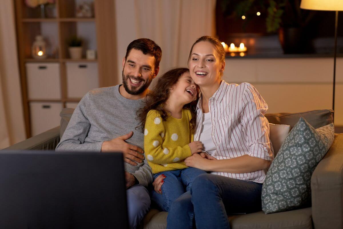 The images show a group of families watching a live-streamed holiday concert online and enjoying the music from the comfort of home.