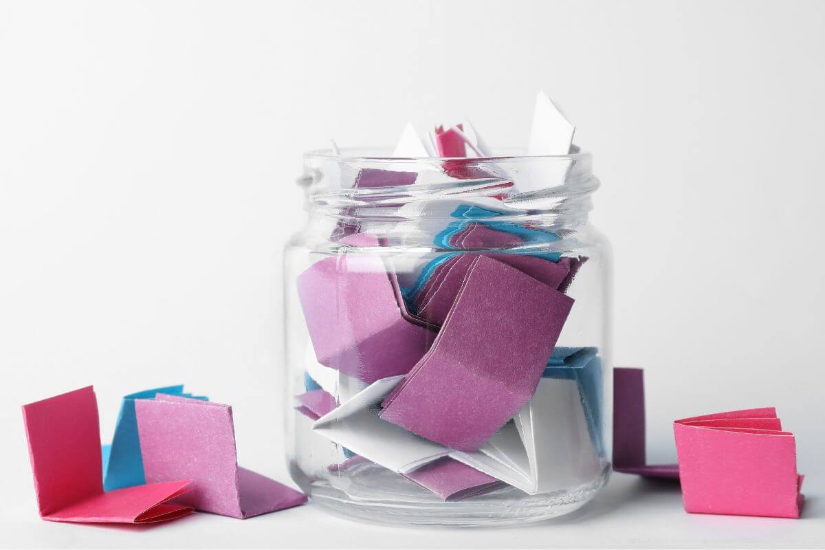 The image tells about the paper on the table and a jar filled with papers which refers to creating a time capsule for the upcoming year to open on the future Christmas for a meaningful look back.