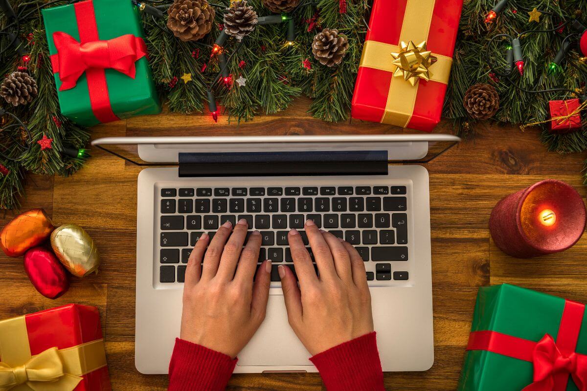 The image tells about a Christmas tree, gifts, and a girl's hand using a laptop which refers to finding more things to do on Christmas day and creating memories with loved ones.