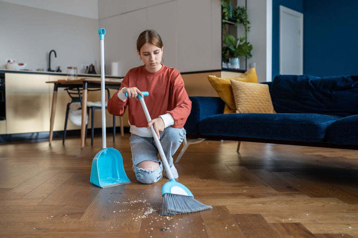 The picture of a teen girl cleaning the living room indicating to run errands for neighbors that can fit your schedule easily and a simple way to make extra money.