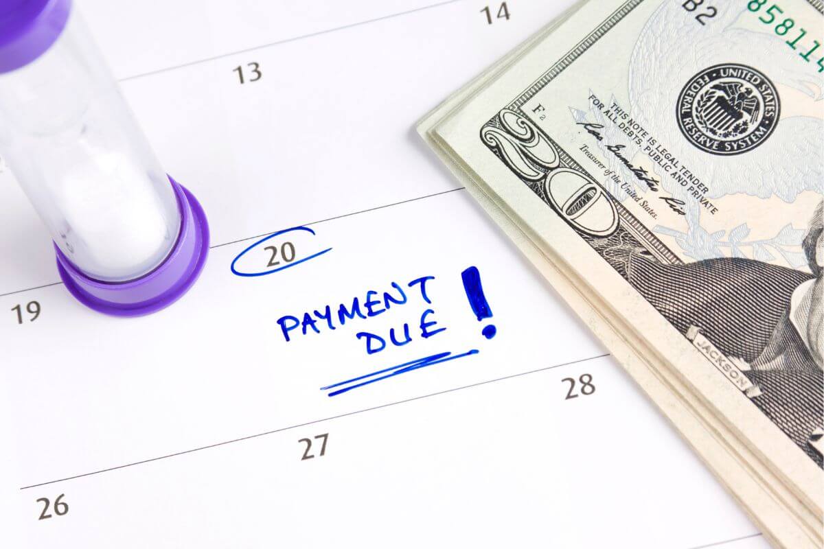 The picture shows dollar bills in a calendar with notes indicating that monthly debt payments taking 20-30% of income can make it hard to save or cover basics.