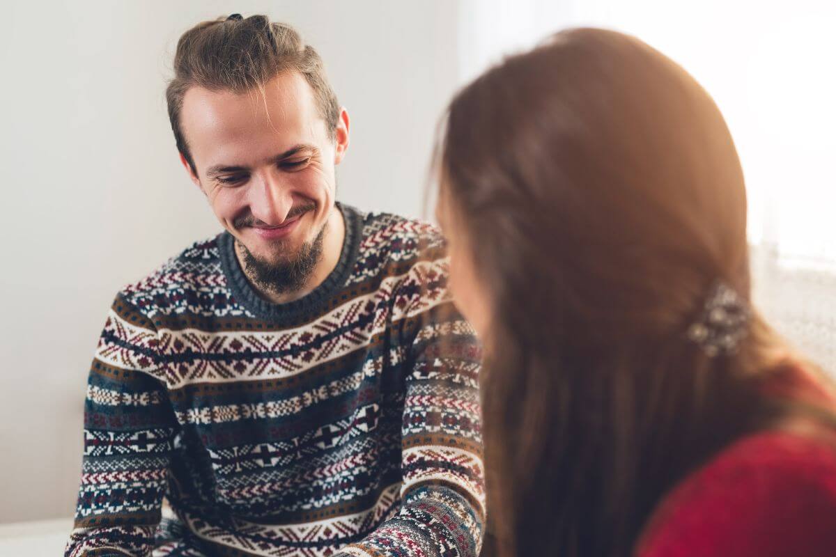 The image shows a couple having their conversation together by choosing a calm and neutral time to start the conversation about money, which helps lower the chance of an argument.