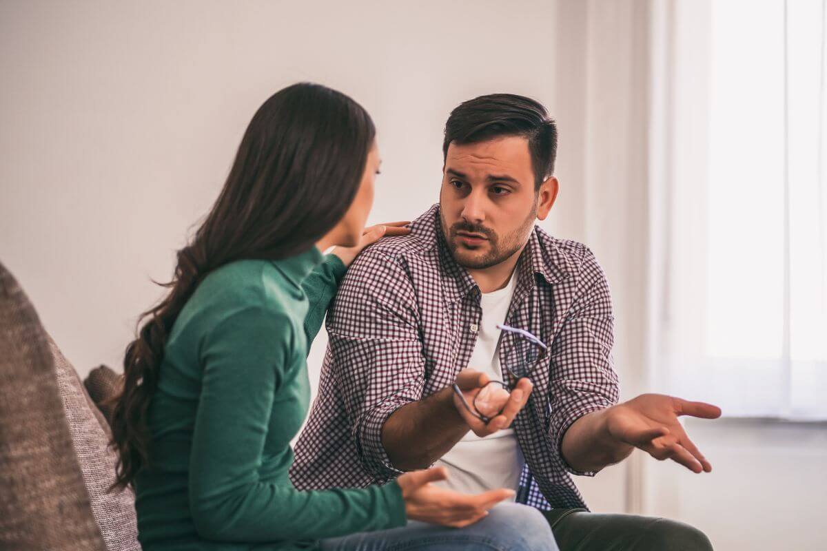 The image of a couple talking together which refers to listening to your partner's perspective without interrupting makes it easier to find common ground and build trust.