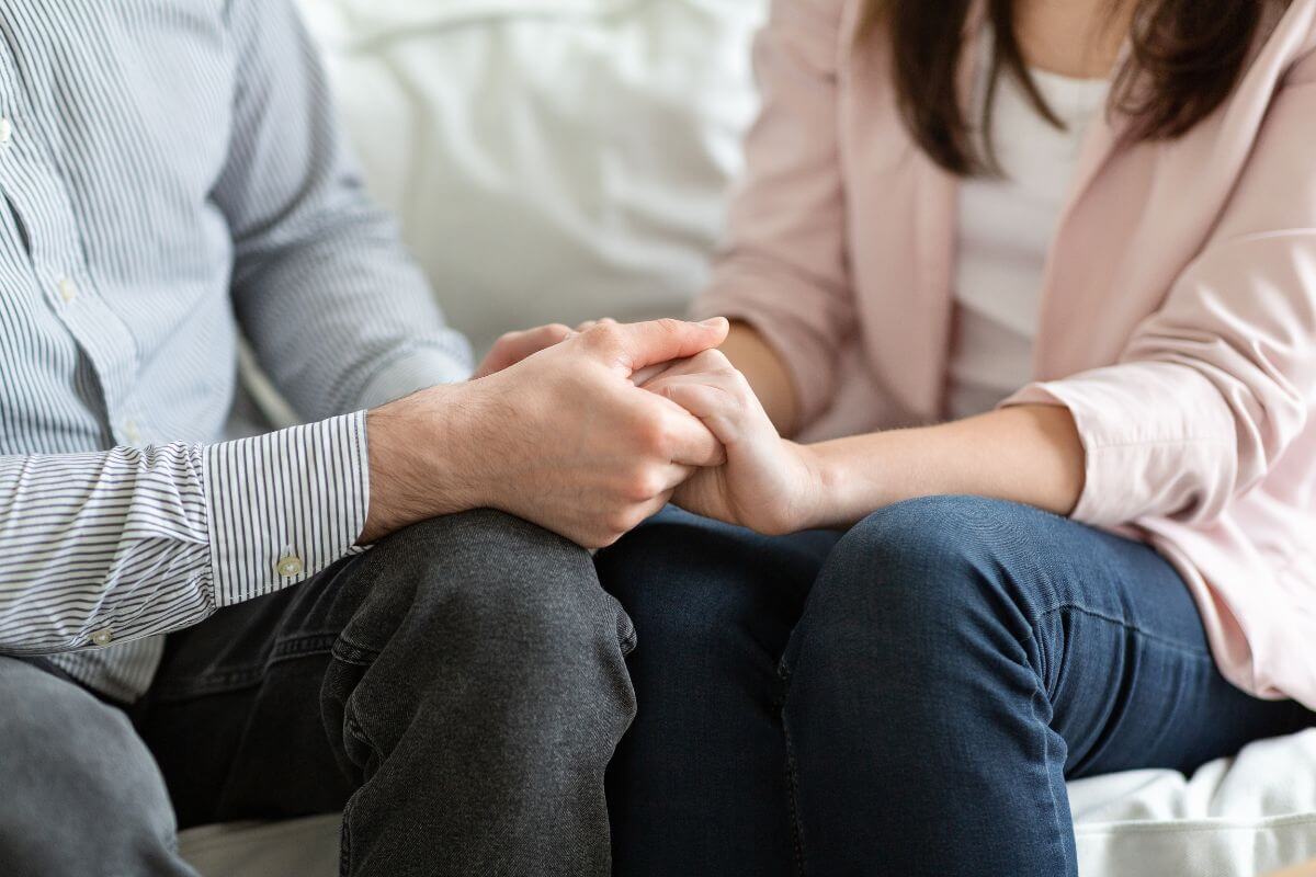 The photo of a couple holding hands together means to focus on "we" when discussing finances and working together to create stronger financial habits and build trust in your relationship.