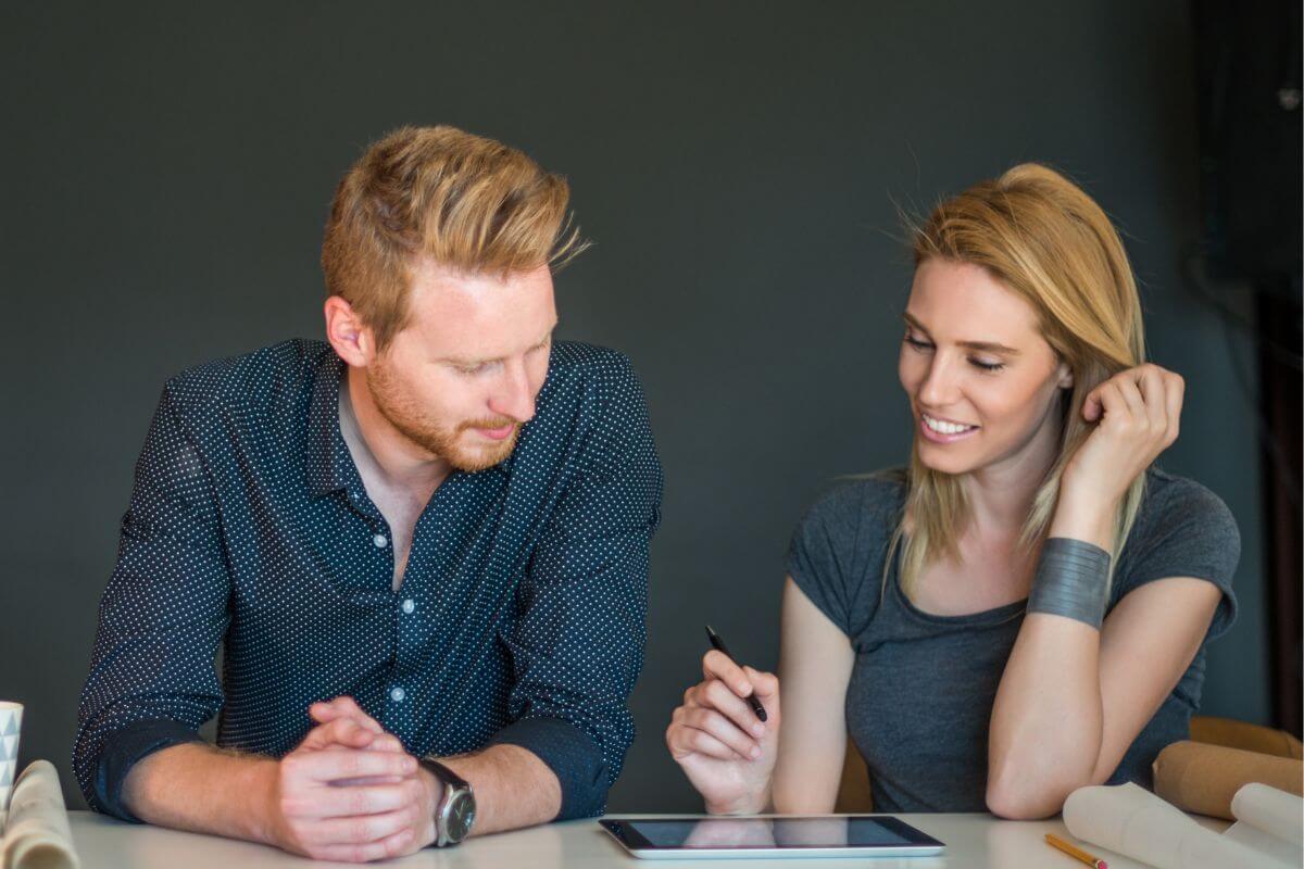 The image shows a couple using a tablet device together referring to being willing to compromise and find solutions together to avoid arguments about money and make it easier to create a plan you're both happy with.