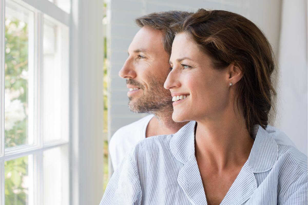 The picture tells about a couple looking at the window indicating that keeping the focus on building a future, not past mistakes helps strengthen your relationships and keeps the conversation hopeful.