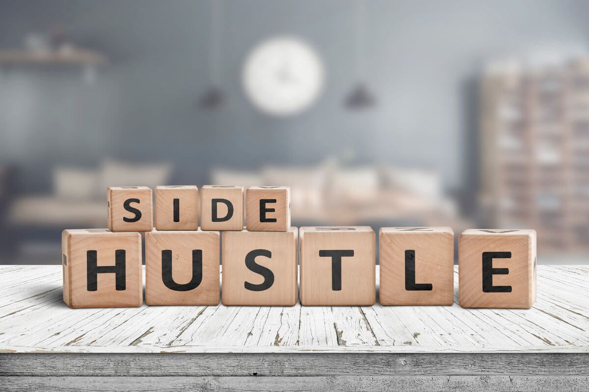 The picture tells about wooden cubes with letters which means to increase income through side jobs to earn extra money and directly to your debt.