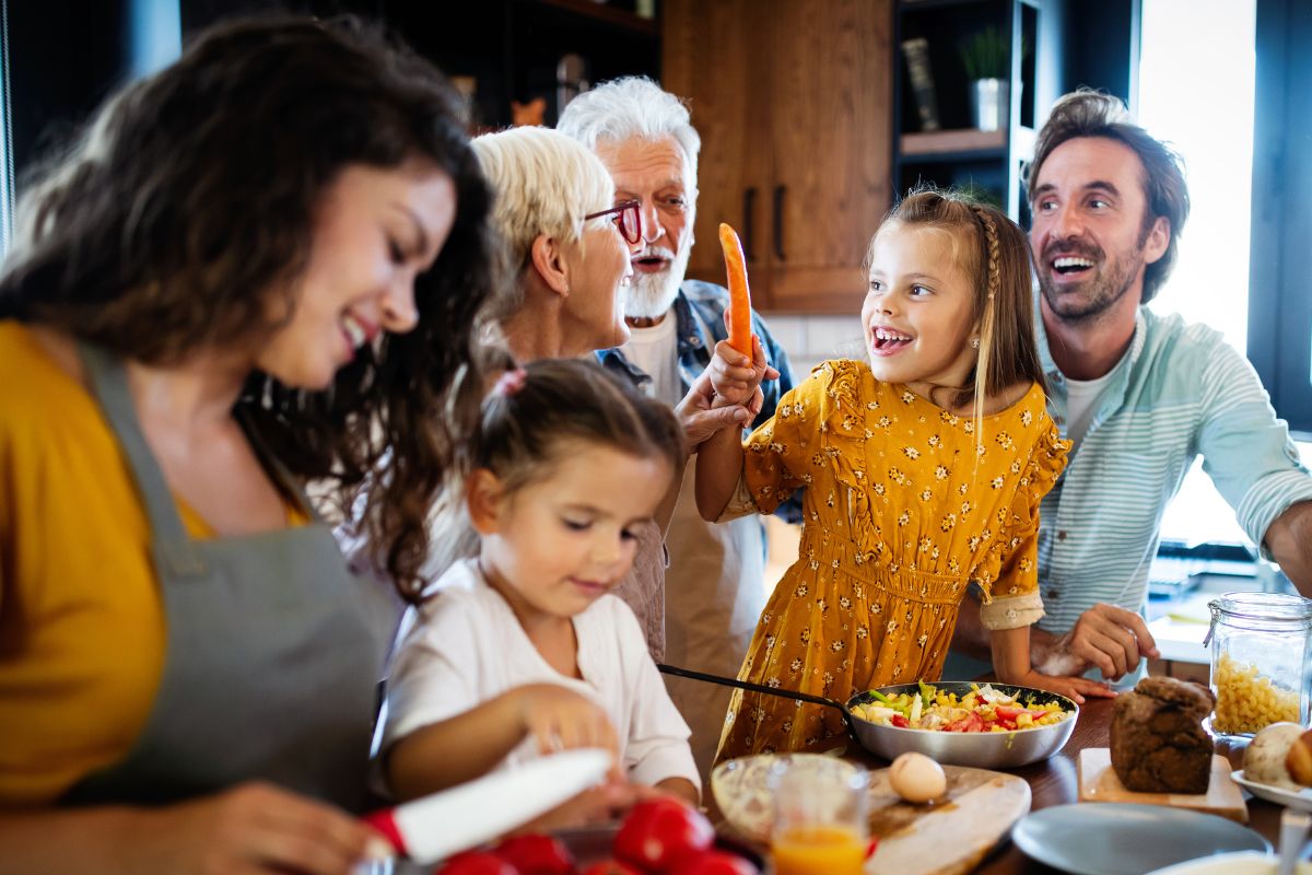 The photo shows a family cooking together.