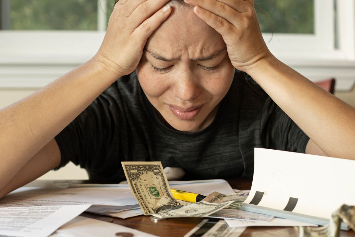 The picture shows a woman with financial stress.