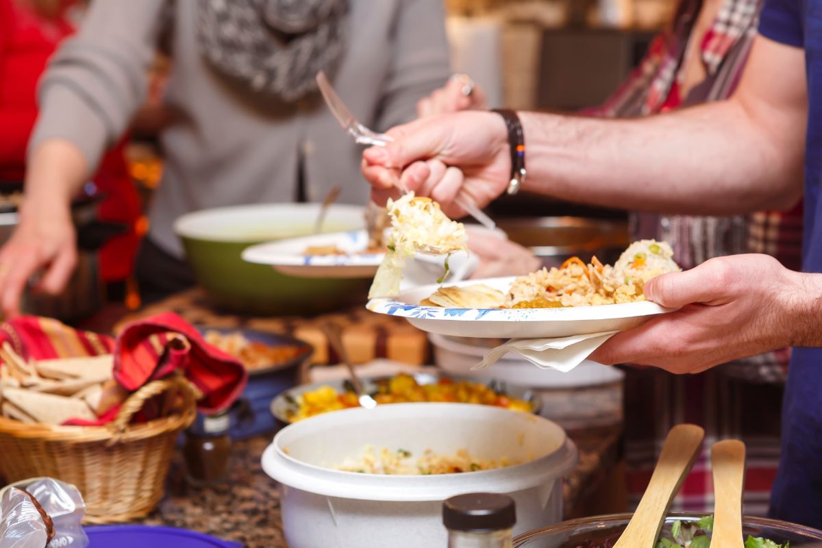 The photo shows a potluck gathering.