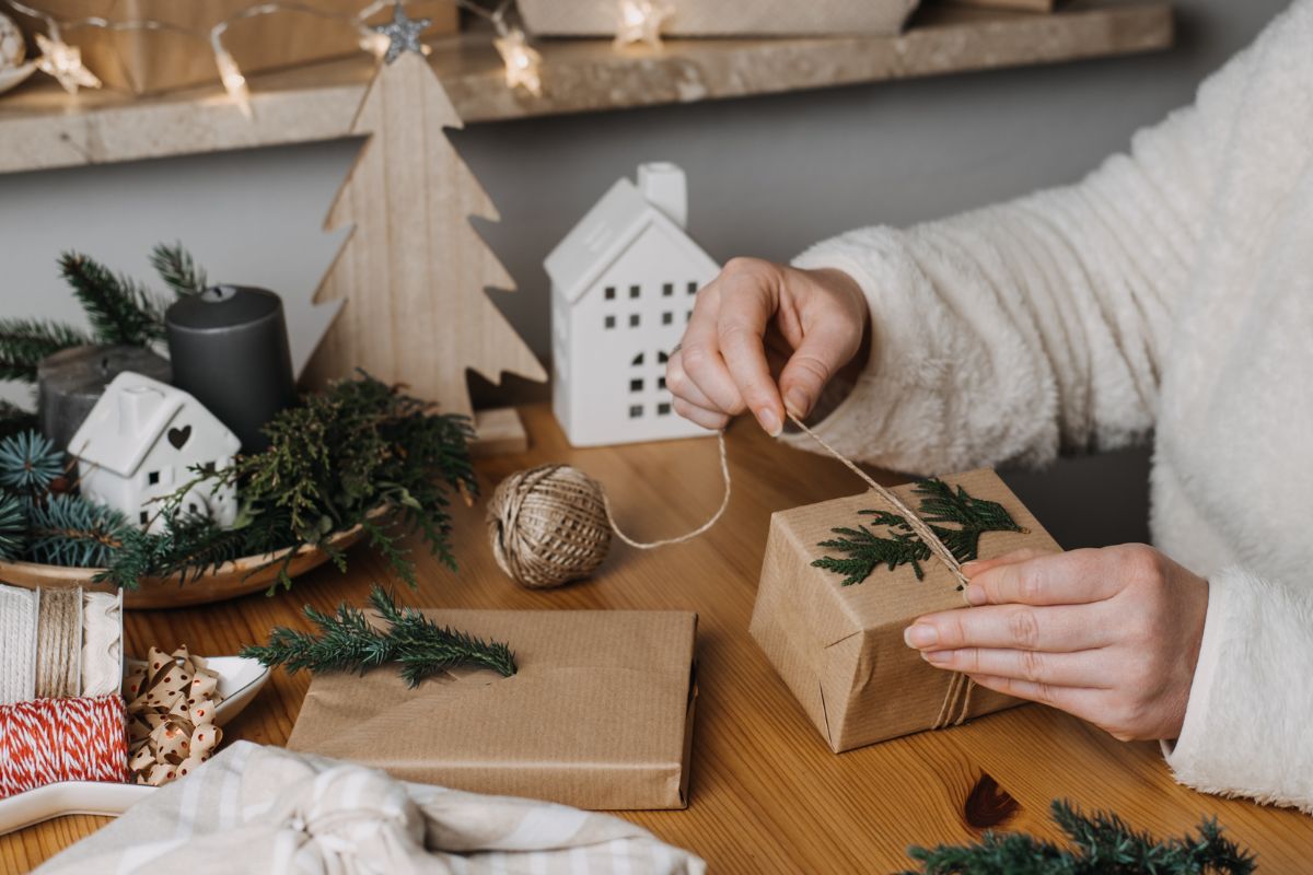 Photo of a woman wrapping a gift.