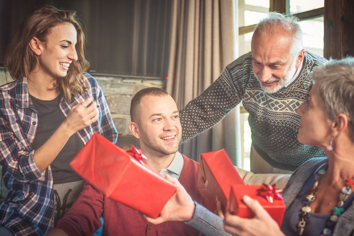 Photo of a family exchanging gifts.