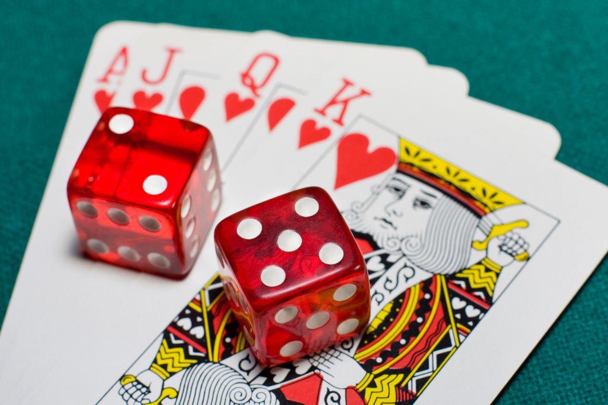 The picture shows dice and gambling cards.