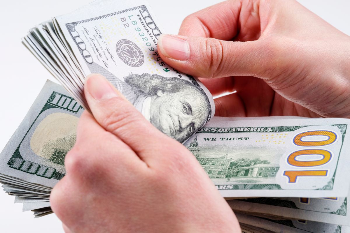 A woman's hand counting money.