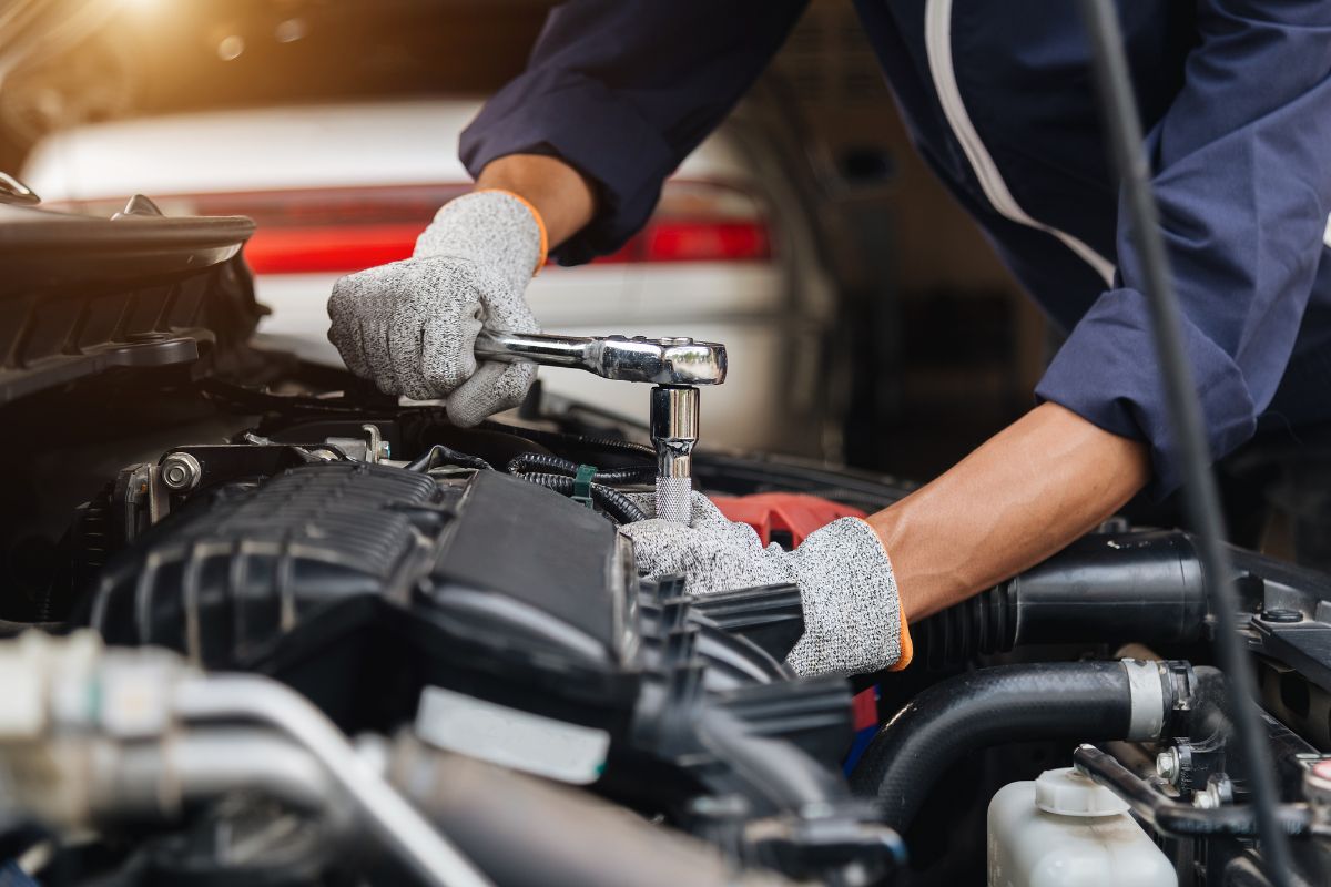 A man repairing a car.