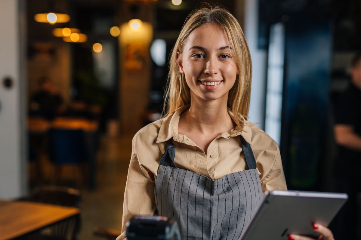 The photo shows a young lady working part-time.