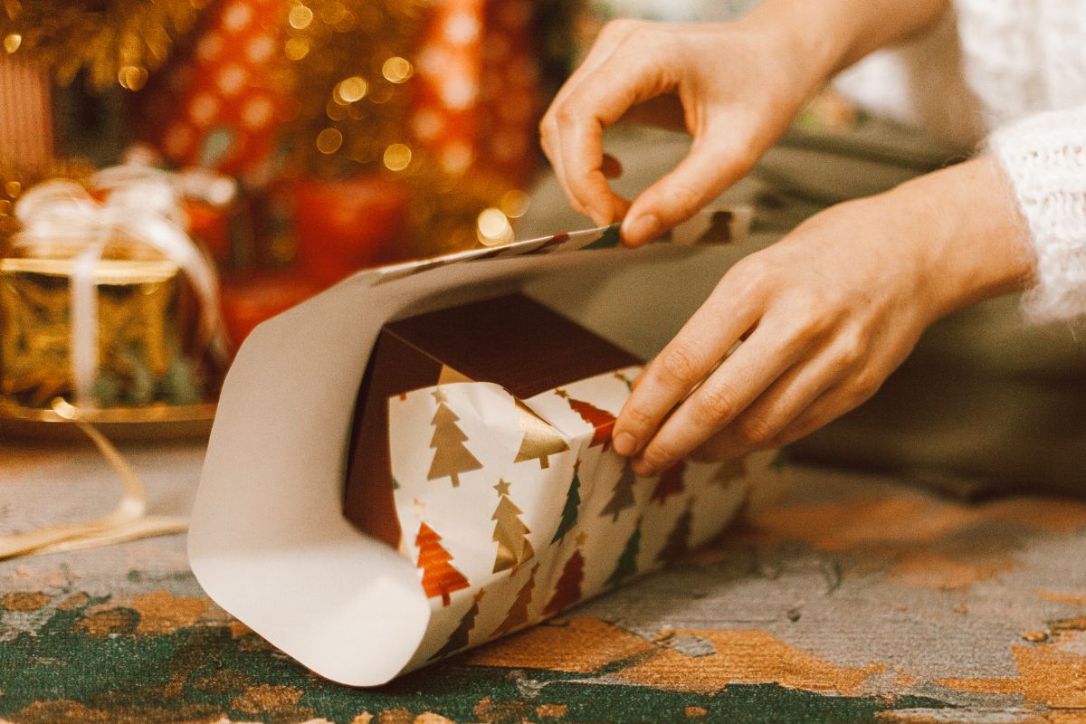 Picture of a woman wrapping a gift.