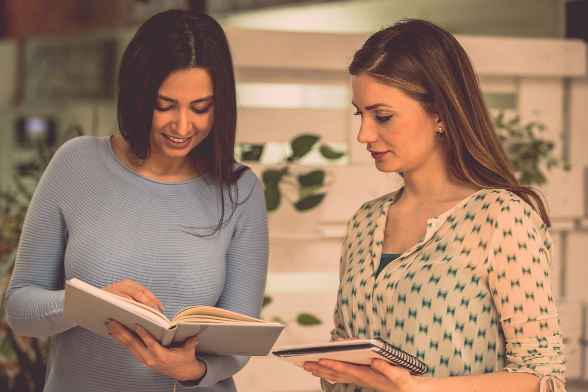 Picture of women comparing their notes.