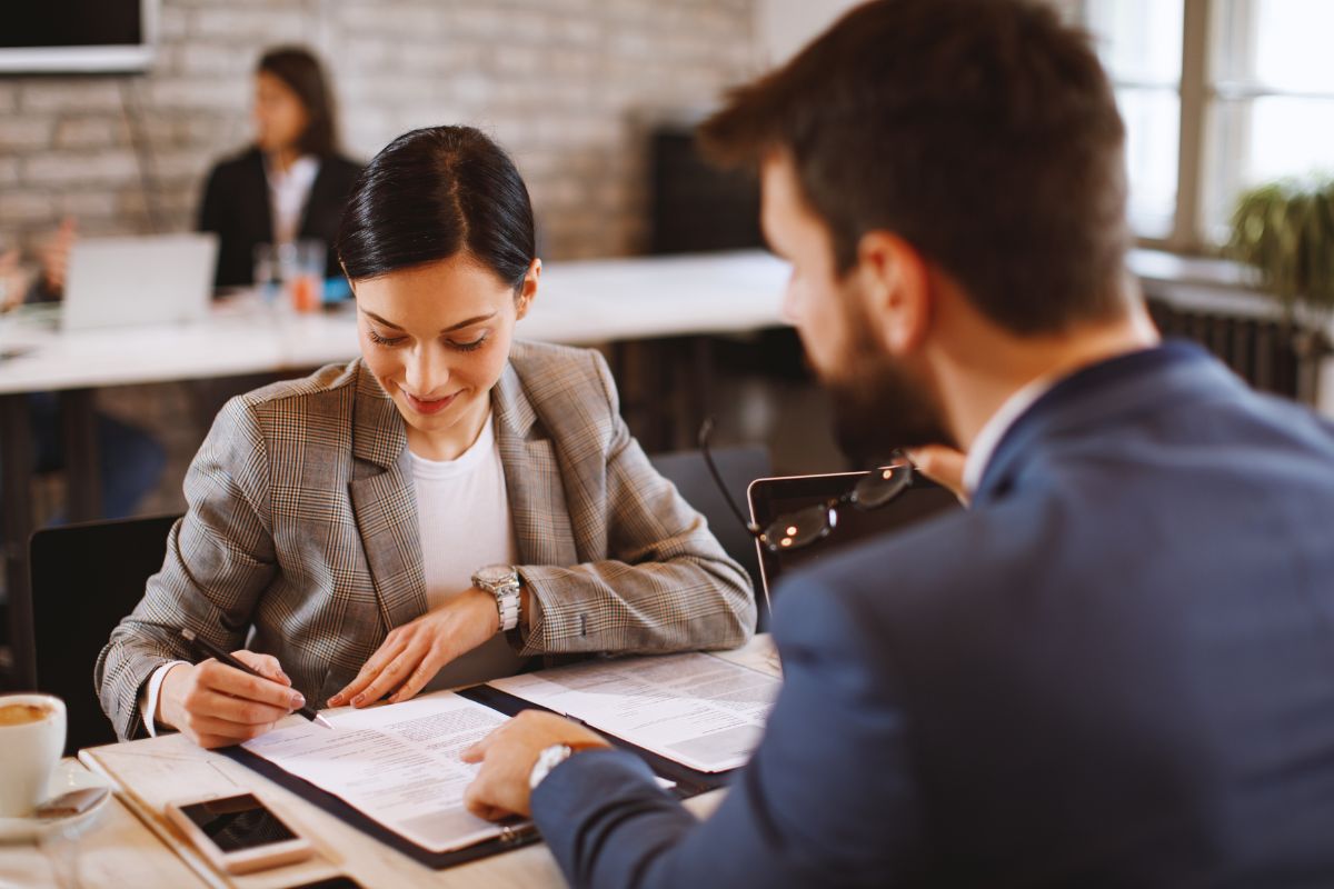 A young woman signed a student loan assistant.