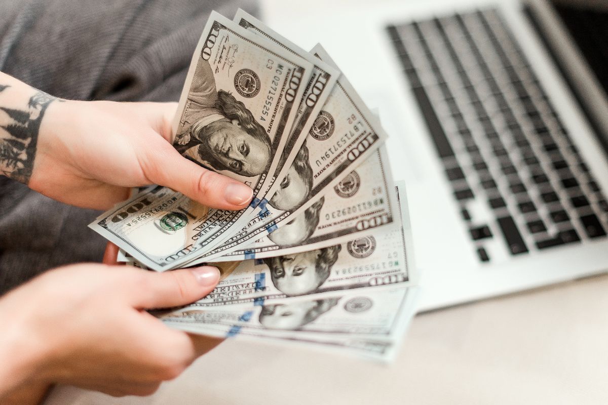 A woman's hand holding money.