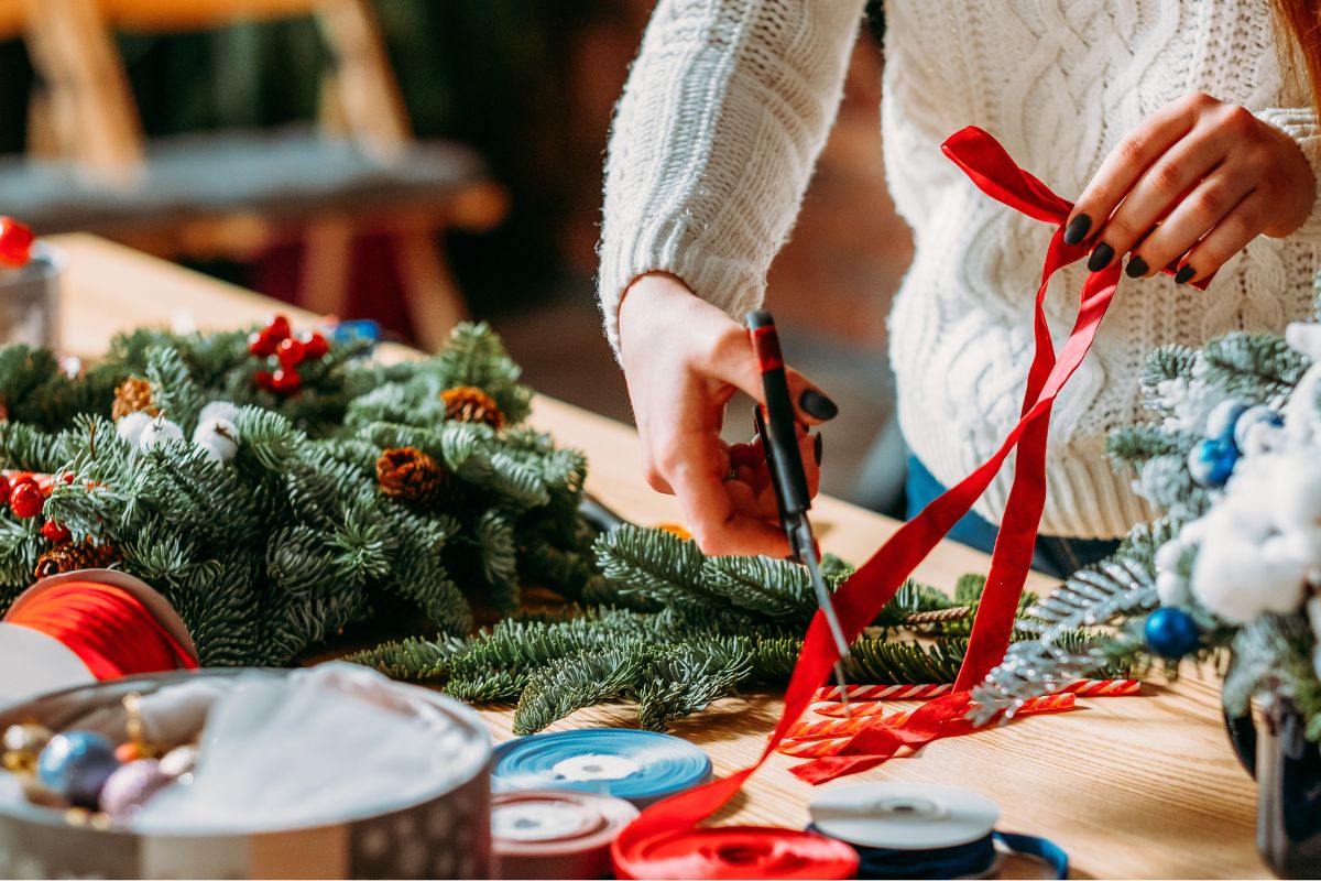 A woman reusing the Christmas decorations.